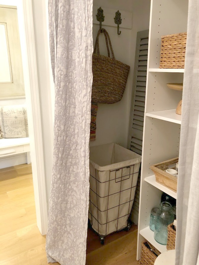 Come see how I made our awful little pass through laundry room next to the garage function better and look peaceful with simple inexpensive DIY - Hello Lovely Studio. #beforeafter #laundryroom #diy #makeover #serenedecor