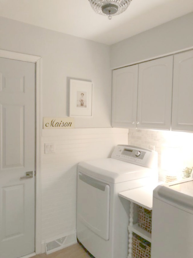 Come see how I made our awful little pass through laundry room next to the garage function better and look peaceful with simple inexpensive DIY - Hello Lovely Studio. #beforeafter #laundryroom #diy #makeover #serenedecor