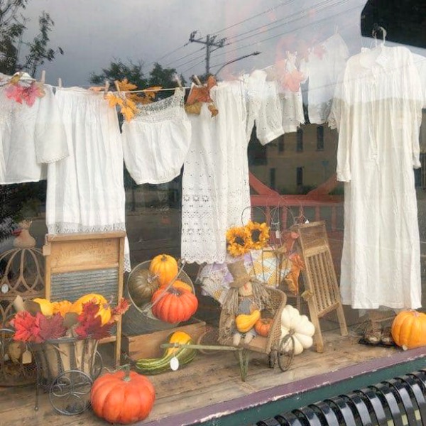 Pick a Dilly Antiques in Rockton, IL - the shop window looks darling with its clothesline of white linens and fall pumpkins.