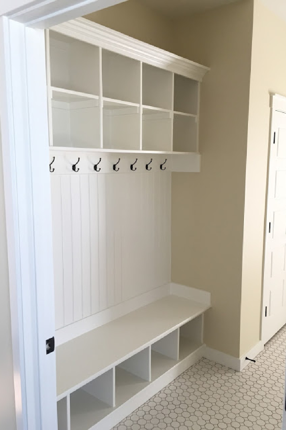 PPG Delicate White paint color on built-ins in a mud room by designer Andrea West. #delicatewhite #paintcolors #mudroom