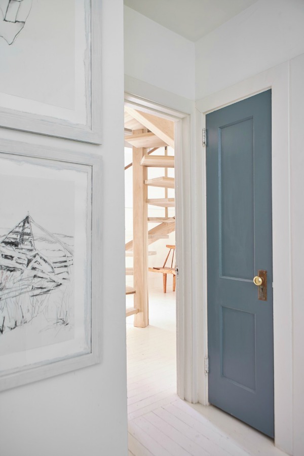 In the staircase room a door is painted PPG Phantom - as part of the Smith project on HGTV's Restored by the Fords with design by Leanne Ford. #paintcolors #interiordesign #ppg #phantom #leanneford #restoredbythefords