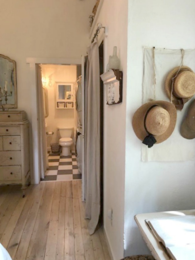 Serene and peaceful, this cottage bedroom with farmhouse style and vintage furniture at Storybook Cottage (Leiper's Fork, TN) was designed by Kim Leggett of City Farmhouse. #farmhousestyle #storybookcottage #cityfarmhouse #bedroom #farmhousebedroom