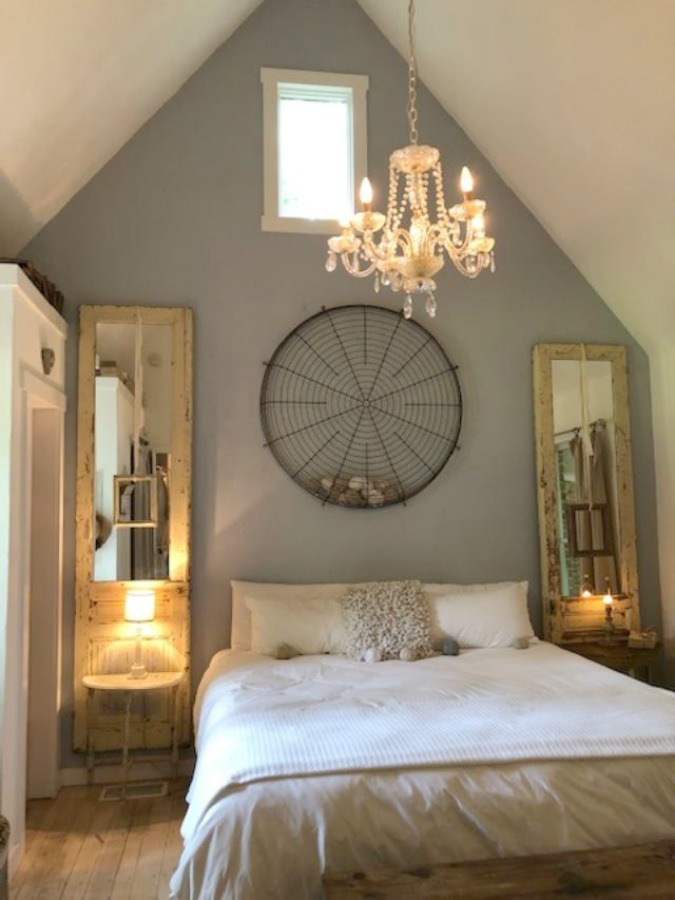 Serene and peaceful, this cottage bedroom with farmhouse style and vintage furniture at Storybook Cottage (Leiper's Fork, TN) was designed by Kim Leggett of City Farmhouse. #farmhousestyle #storybookcottage #cityfarmhouse #bedroom #farmhousebedroom