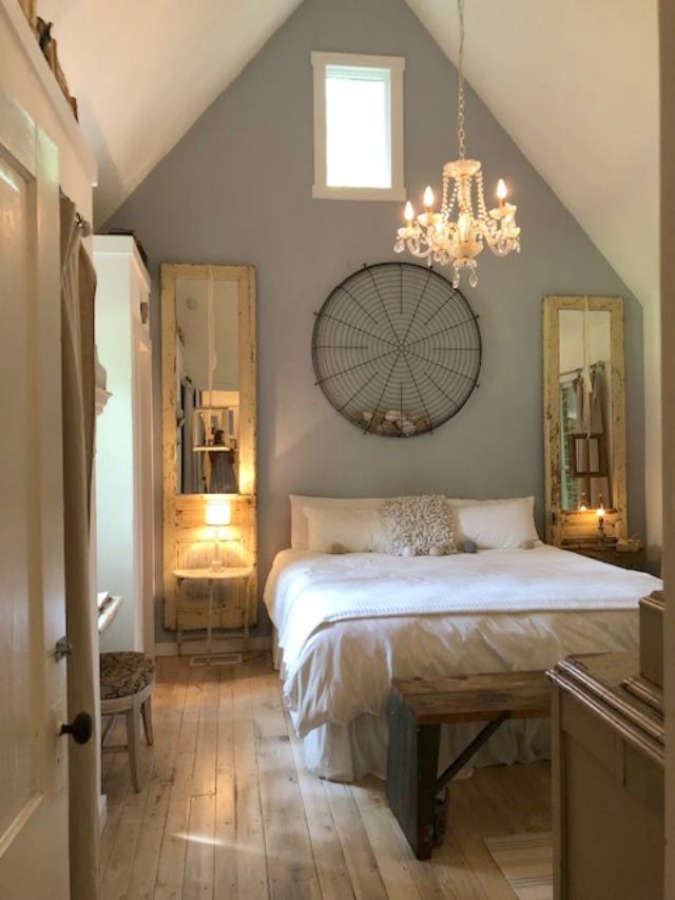 Serene and peaceful, this cottage bedroom with farmhouse style and vintage furniture at Storybook Cottage (Leiper's Fork, TN) was designed by Kim Leggett of City Farmhouse. Discover these 7 Better Night's Sleep Reminders if You Are Stressed as well as shopping resources.