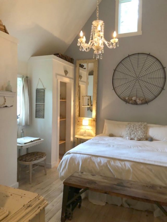 Serene and peaceful, this cottage bedroom with farmhouse style and vintage furniture at Storybook Cottage (Leiper's Fork, TN) was designed by Kim Leggett of City Farmhouse. #farmhousestyle #storybookcottage #cityfarmhouse #bedroom #farmhousebedroom