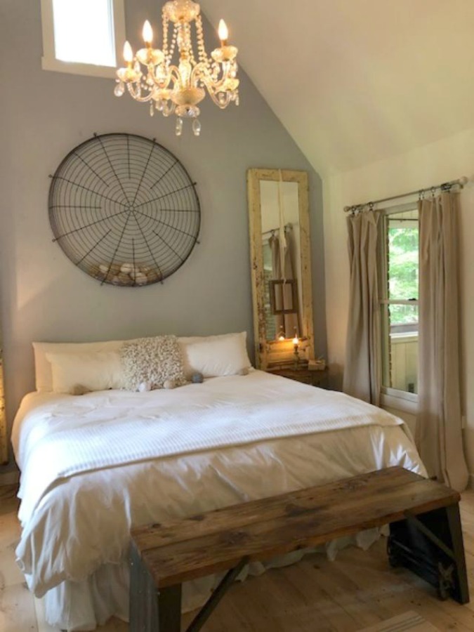 Serene and peaceful, this cottage bedroom with farmhouse style and vintage furniture at Storybook Cottage (Leiper's Fork, TN) was designed by Kim Leggett of City Farmhouse. #farmhousestyle #storybookcottage #cityfarmhouse #bedroom #farmhousebedroom