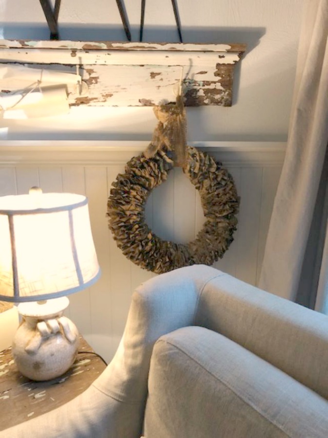 Farmhouse chic living room with vintage treasures, bold yellow painted poplar wood flooring, linen upholstery, and design by City Farmhouse for Storybook Cottage in Leiper's Fork, TN - Hello Lovely Studio. #farmhousestyle #livingroom #cityfarmhouse #storybookcottage