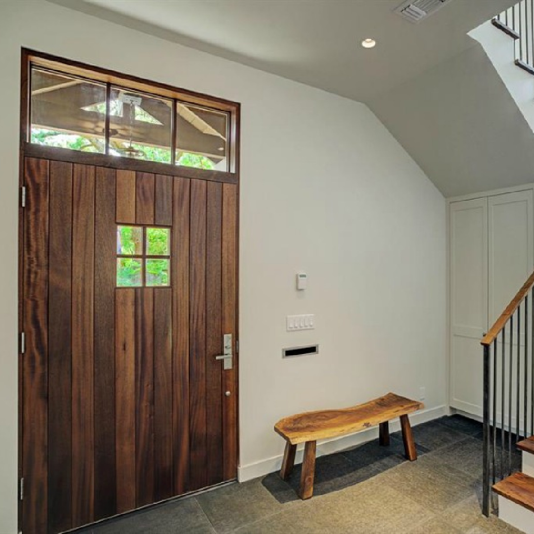 Minimal and simple sophisticated entry with plaster walls and warm wood a zen home by architect Kelly Cusimano and crafted by Marcellus Barone of Southampton Homes. #belgianstyle #staircasedesign #mcm