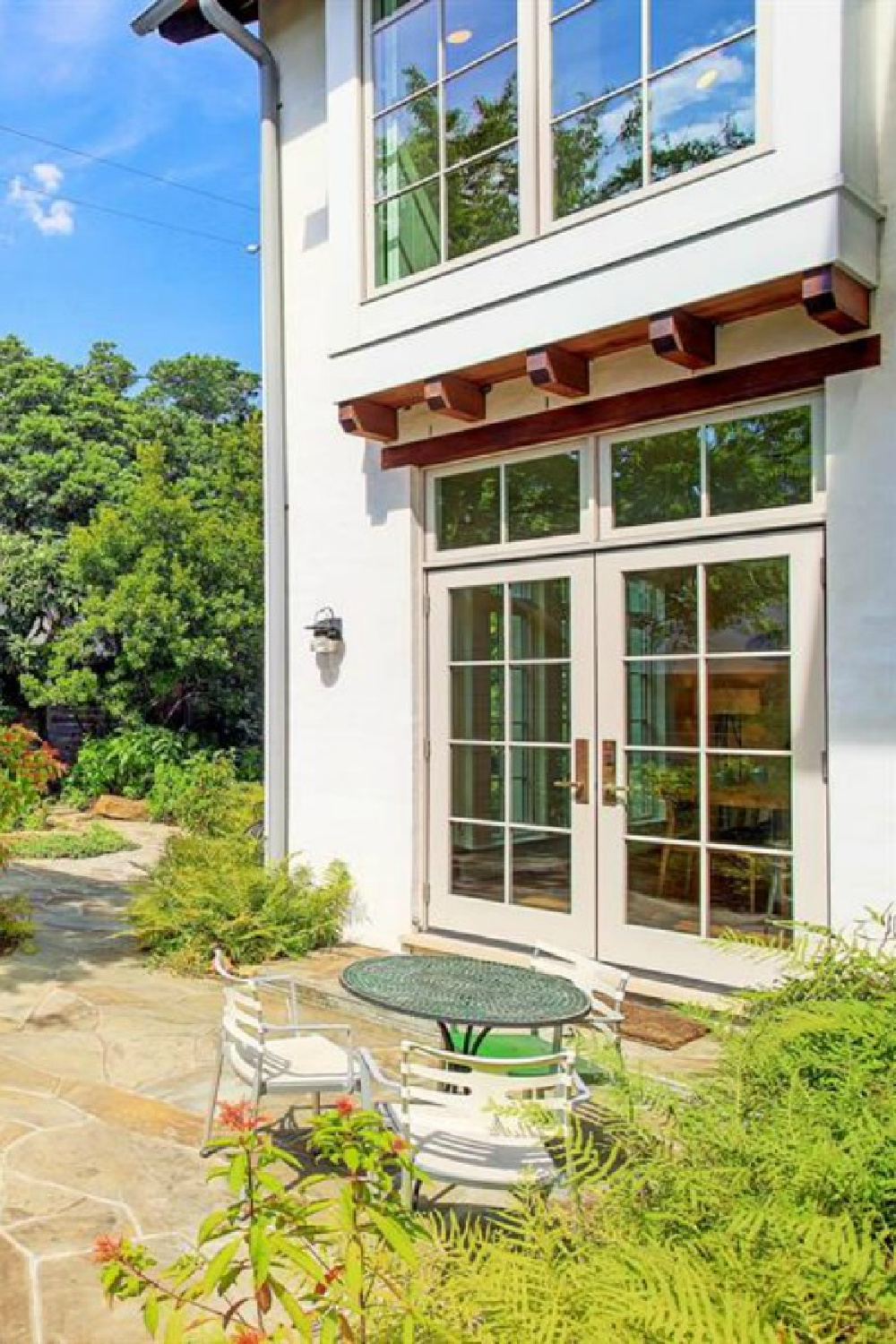 View of patio and garden from a magnificent traditional Houston home by architect Kelly Cusimano and crafted by Marcellus Barone of Southampton Homes. #belgianartchitecture #houseexterior #oldworld #minimal