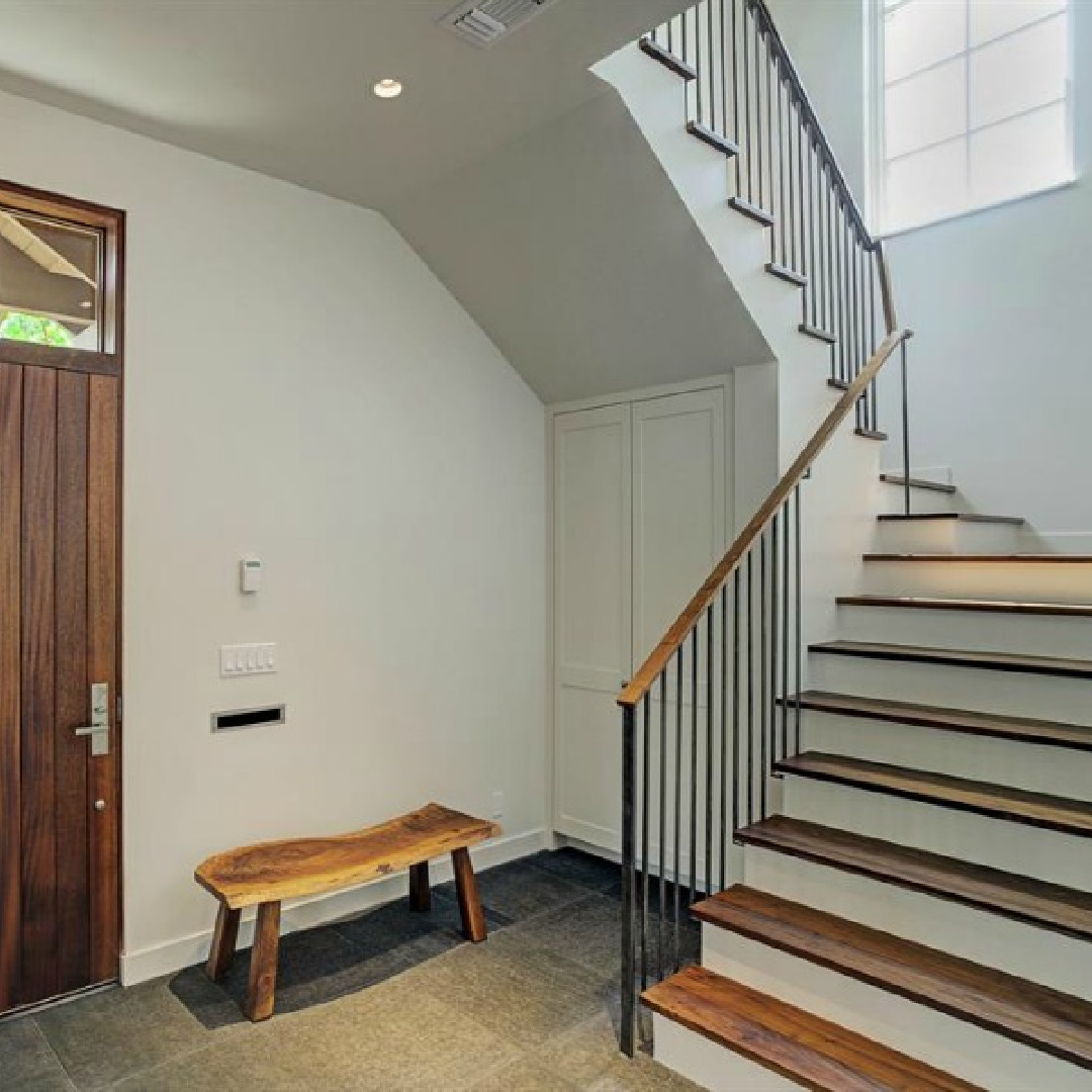 Minimal and simple sophisticated entry with plaster walls and warm wood a zen home by architect Kelly Cusimano and crafted by Marcellus Barone of Southampton Homes. #belgianstyle #staircasedesign #mcm