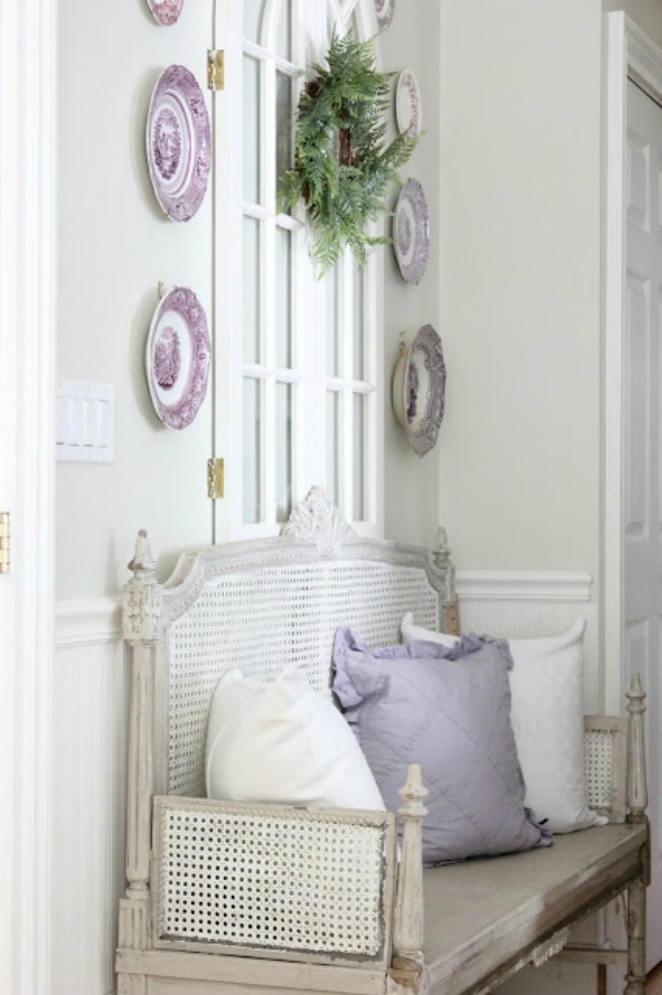 French country settee bench with purple transferware plates displayed on wall above - Maison Decor/Amy Chalmers. #frenchcountry #settee #interiordesign