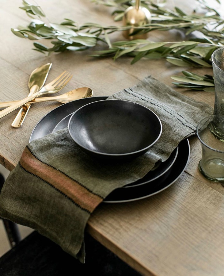 Deep richly colored rustic fall tablescape with gold flatware - Beautiful Mess Home. #placesetting #autumn #rusticdecor