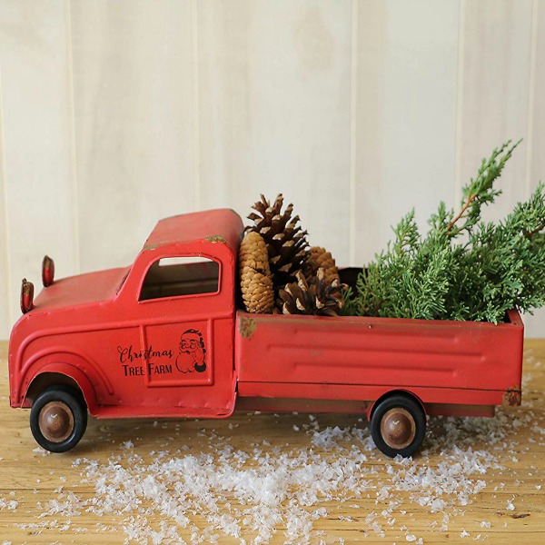 Whimsical vintage style red tin pickup truck with Christmas tree. #holidaydecor #christmasdecorating #pickuptruck #vintagestyle