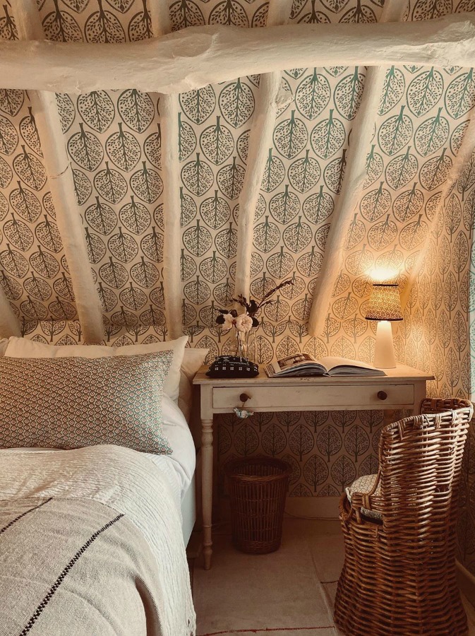 Charming Cotswolds cottage rustic bedroom with leaf wallpaper and vintage charm - design by Faeger and Co. #cotswolds #cottagebedroom #interiordesign #wallpaper #rusticdecor