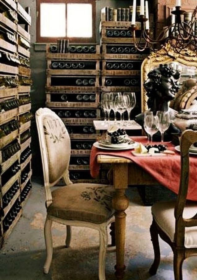 A charming French country dining vignette in a wine cellar with design by EurotrashAnnie. #winecellar #frenchcountry #louischair #interiordesign