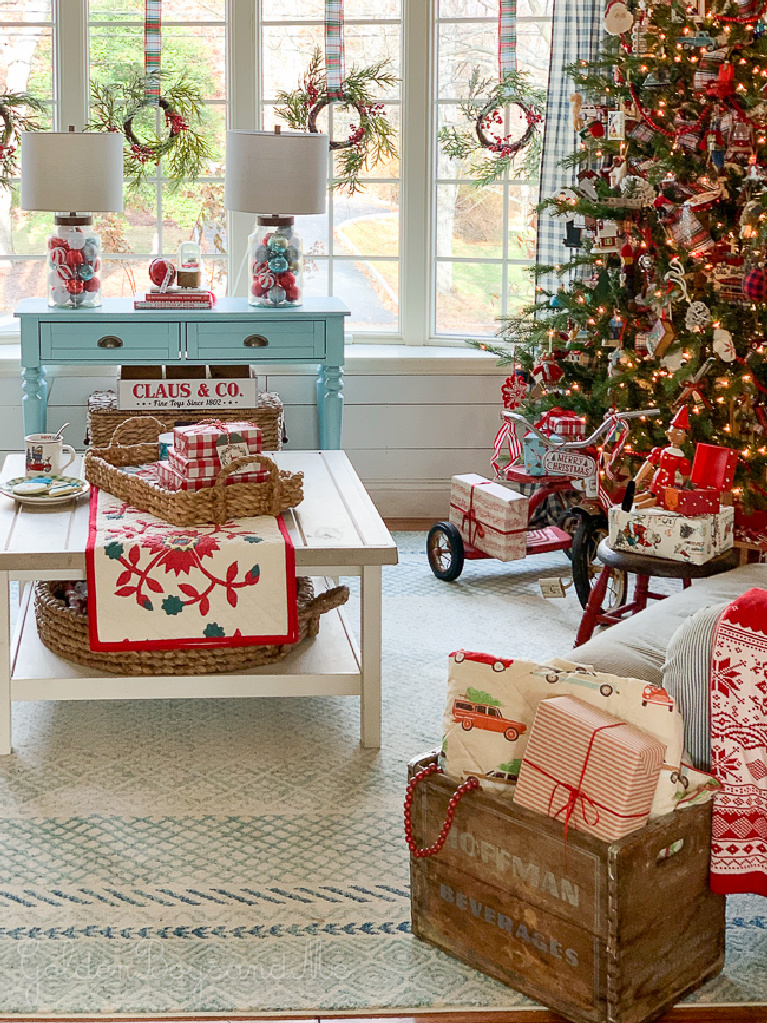 Darling and whimsical Christmas decor in a cheerful cottage living room with pinks and aquas - Goldenboysandme. #whimsicalchristmas #christmasdecor #livingroom #cottagestyle #farmhousechristmas