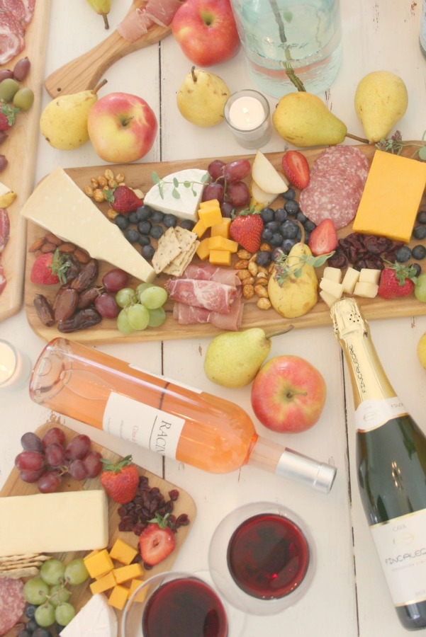 Vibrant colors for these easy to assemble graze boards (cheese boards!) with fruit, nuts, and wine - Hello Lovely Studio. #grazeboard #howto #cheeseboard #entertaining #cheese