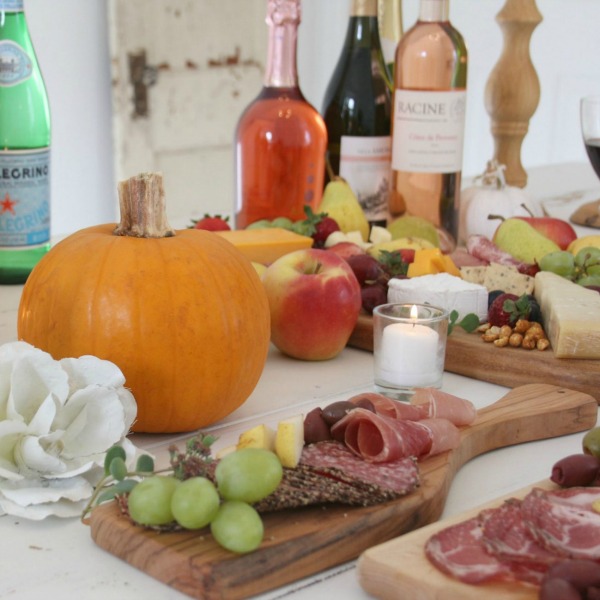 Vibrant colors for these easy to assemble graze boards (cheese boards!) with fruit, nuts, and wine - Hello Lovely Studio. #grazeboard #howto #cheeseboard #entertaining #cheese
