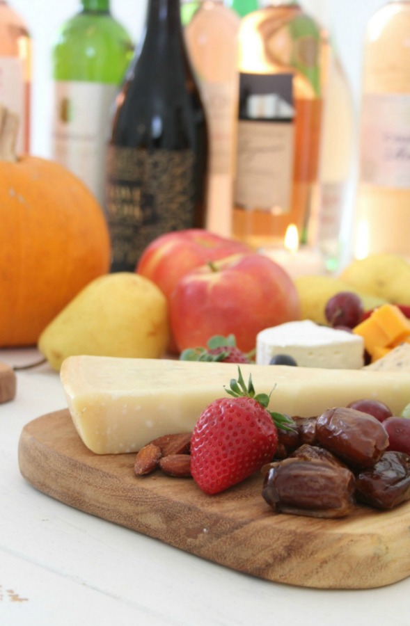 Vibrant colors for these easy to assemble graze boards (cheese boards!) with fruit, nuts, and wine - Hello Lovely Studio. #grazeboard #howto #cheeseboard #entertaining #cheese