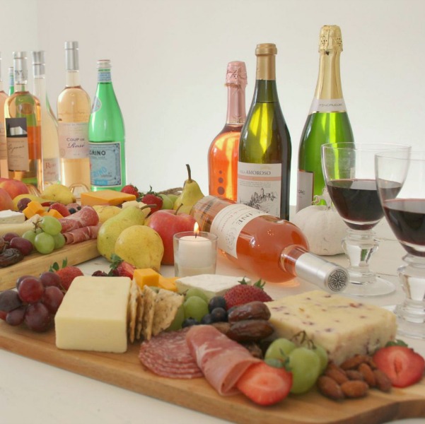 Vibrant colors for these easy to assemble graze boards (cheese boards!) with fruit, nuts, and wine - Hello Lovely Studio. #grazeboard #howto #cheeseboard #entertaining #cheese