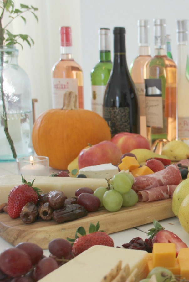 Vibrant colors for these easy to assemble graze boards (cheese boards!) with fruit, nuts, and wine - Hello Lovely Studio. #grazeboard #howto #cheeseboard #entertaining #cheese