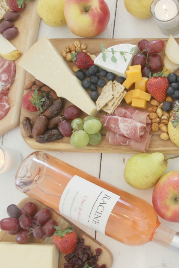 Vibrant colors for these easy to assemble graze boards (cheese boards!) with fruit, nuts, and wine - Hello Lovely Studio. #grazeboard #howto #cheeseboard #entertaining #cheese