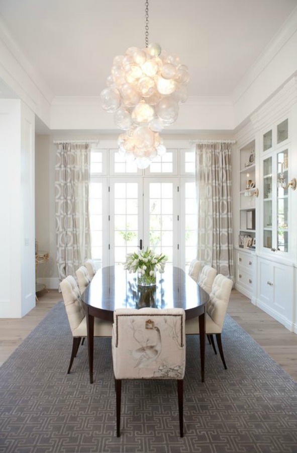 Dining room with white built-ins and soaring ceilings in a home with modern French interior design in Queen Creek, AZ. #modernfrench #diningroom