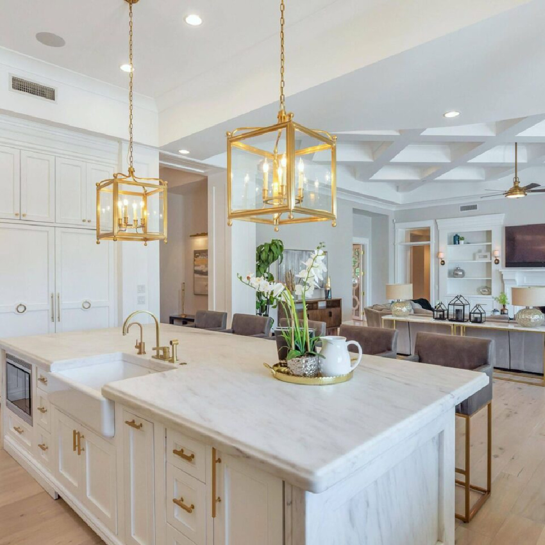 Modern French kitchen and great room with gilded lanterns and light grey walls. #modernfrench #gildedlanterns