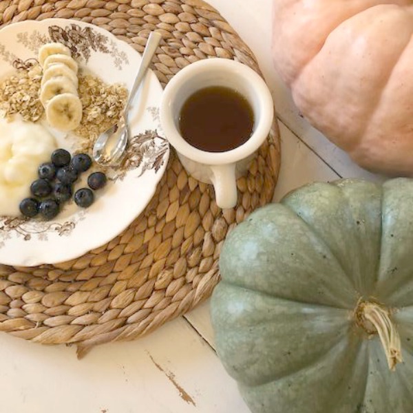 Soft serene fall color palette decor from Cinderella pumpkins, pale pink ballet slippers, and natural fallen leaves upon my kitchen farm table - Hello Lovely Studio. #pastels #softcolors #autumn #decorating #fallcolor #shabbychic