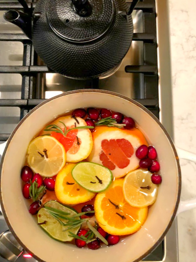 Vividly colorful citrus simmer on the stovetop fragrances the house with grapefruit, rosemary, and fall spices - Hello Lovely Studio.