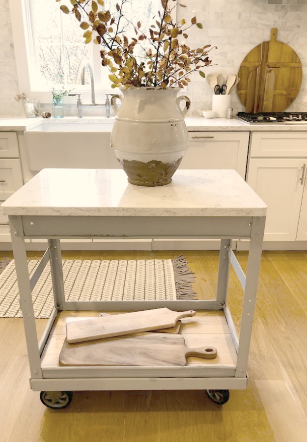 Shaker style white cabinets in simple serene kitchen with white oak floors and Viatera Minuet quartz countertops - Hello Lovely Studio.