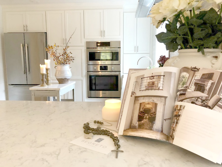 Shaker style white cabinets in simple serene kitchen with white oak floors and Viatera Minuet quartz countertops - Hello Lovely Studio.