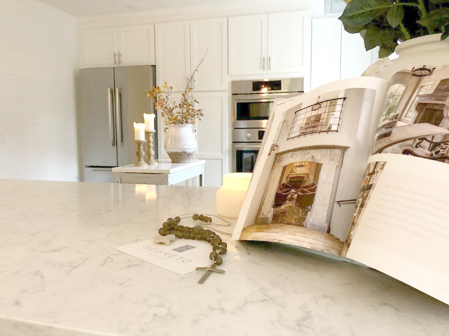 Shaker style white cabinets in simple serene kitchen with white oak floors and Viatera Minuet quartz countertops - Hello Lovely Studio.