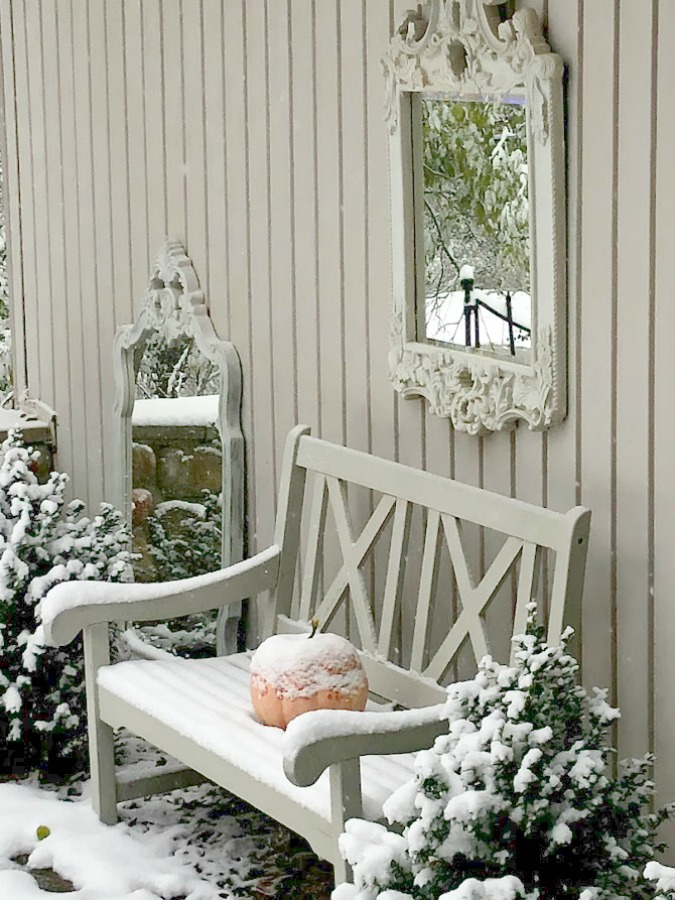 Snowy French country courtyard in Northern Illinois looks serene and peaceful - Hello Lovely Studio. #courtyard #wintergarden #serene
