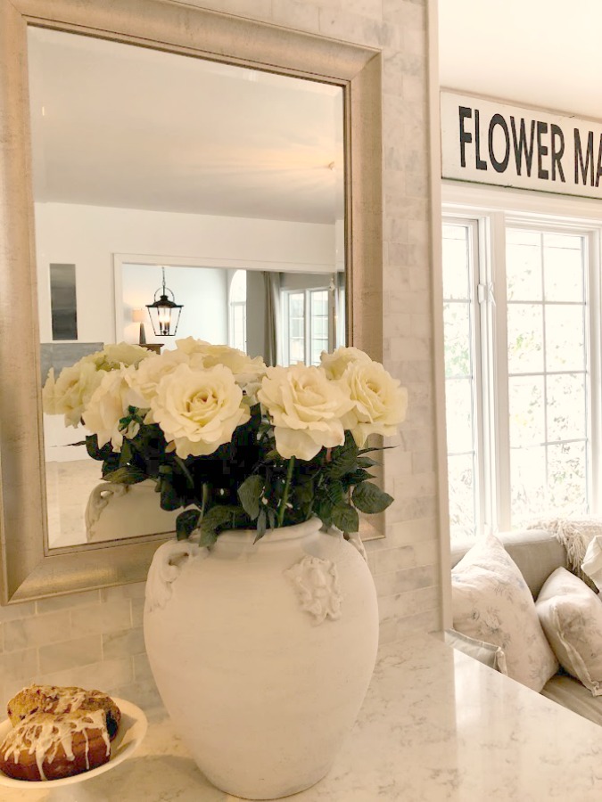 White roses in an oversized terracotta urn planter with handles on my kitchen counter - Hello Lovely Studio. #viateraquartz #minuet #kitchencountertop