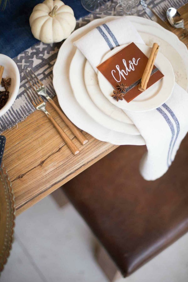 Lovely Thanksgiving table setting idea with blue stripe linen napkins and simple country details - Style Me Pretty. #thanksgivingtable #tablescape #tablesetting #placesetting