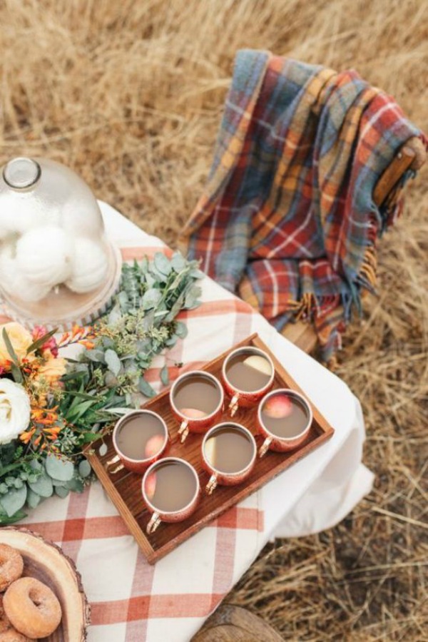 Gorgeous and tranquil outdoor table setting inspiration with muted plaid and warm burnt orange. #tablesetting #falltable #plaid #outdoordining