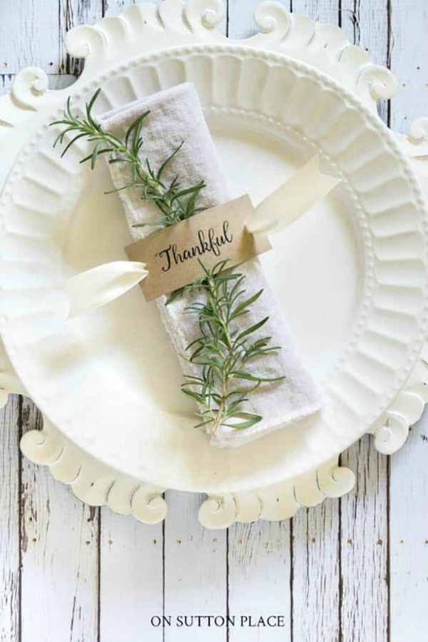 Simple placesetting for fall table or Thanksgiving with rosemary and white plates - On Sutton Place. #thanksgiving #falltable #tablescape #tablesetting #placesetting