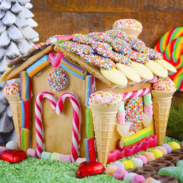 Quirky and fanciful gingerbread house decorated with ice cream cones and bright color candies - Allas.Se #gingerbreadhouse #holidaybaking #christmasdiy