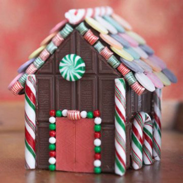 Hershey's chocolate decorated candy house - BHG. #gingerbreadhouse #candyhouse #christmasdiy #christmassweets