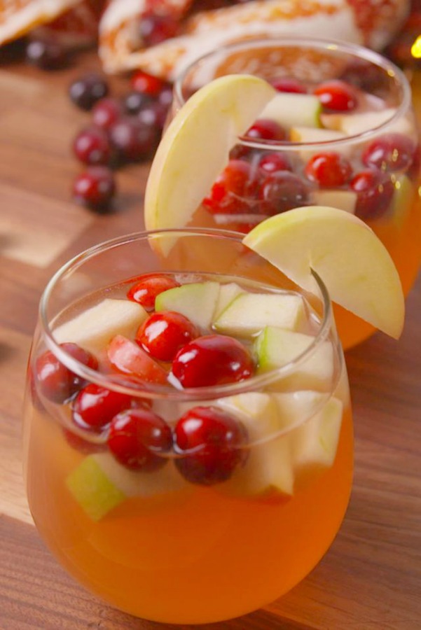 Delicious cocktail or mocktail idea for Thanksgiving with apples and cranberries - sangria recipe from Delish. #sangria #thanksgivingrecipes #thanksgivingmenu #applecranberry