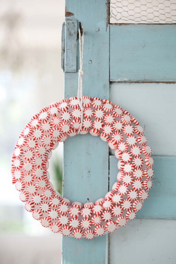 Darling peppermint candy Christmas wreath hanging on light blue farmhouse vintage door - Dreamy Whites. #christmasdecor #peppermintcandy #christmaswreath #dreamywhites