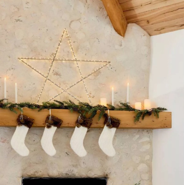 Cozy Christmas mantel with stockings and huge metal star - styling by Emily Henderson for Target. #neutraldecor #whitechristmas #fireplacemantel 