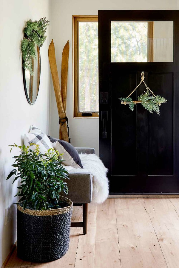 Christmas decorated entry with a natural modern farmhouse prairie vibe - styling by Emily Henderson for Target. #entry #interiordesign #holidaydecor #modernfarmhouse