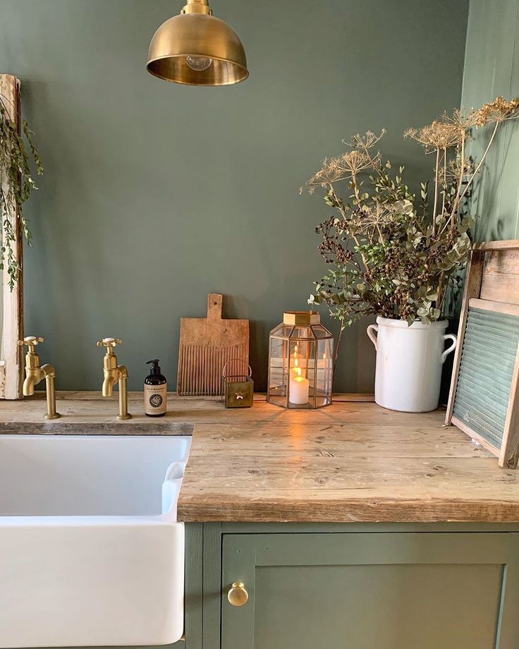 Farrow & Ball Smoke Green on walls and cabinets of a laundry room by Simply Scandi Katie. #farrowandball #smokegreen #paintcolors #deepgreen #greenpaint