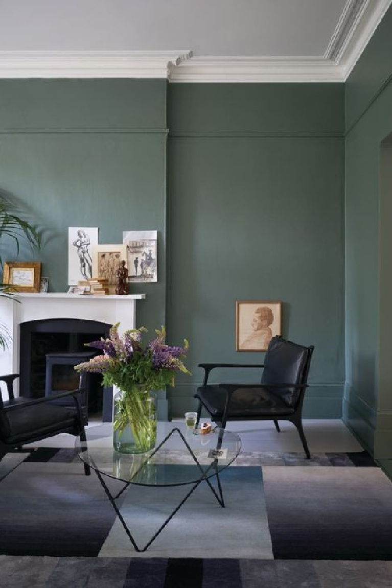 Farrow & Ball Smoke Green painted walls in a living room with European sophisticated style. #farrowandball #smokegreen #paintcolors #deepgreen #moodygreen #greenpaint
