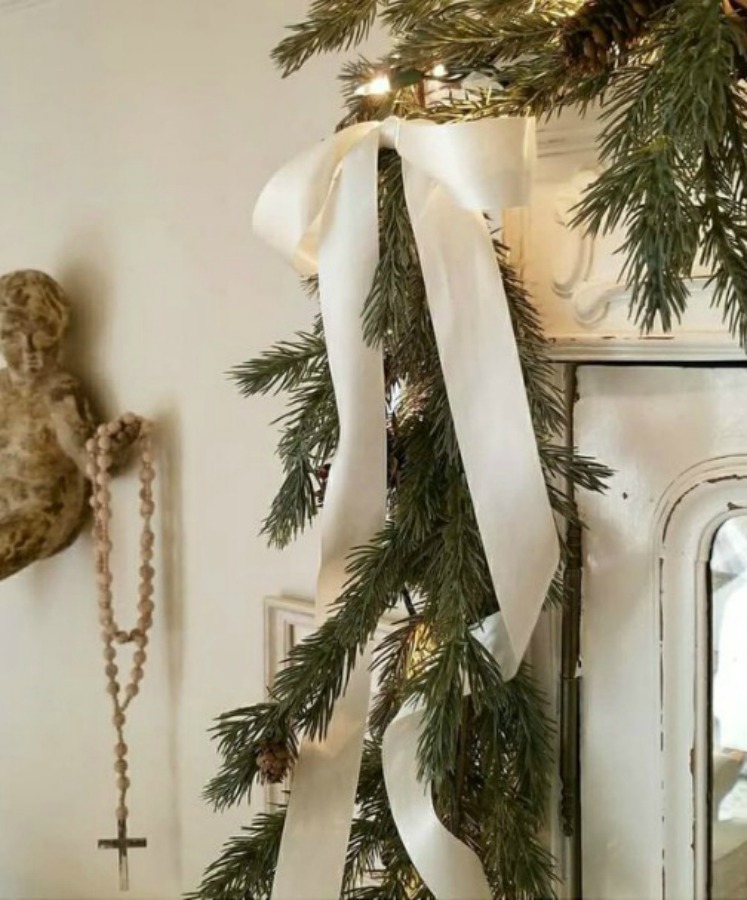 French country Christmas decor with white sophisticated details and greenery. #frenchcountry #frenchchristmas #christmasdecor #whitechristmasdecor