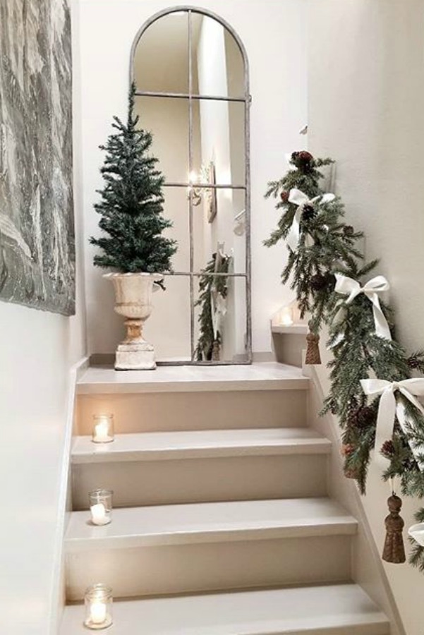 French country Christmas decor with white sophisticated details and greenery. #frenchcountry #frenchchristmas #christmasdecor #whitechristmasdecor