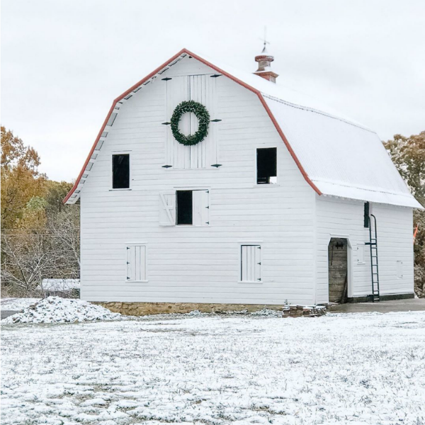 Magnificent white barn with Christmas wreath at a country property in Knoxville, TN - Beside the Mulberry Tree. #christmasdecor #farmhousechristmas #whitebarn #whitechristmas