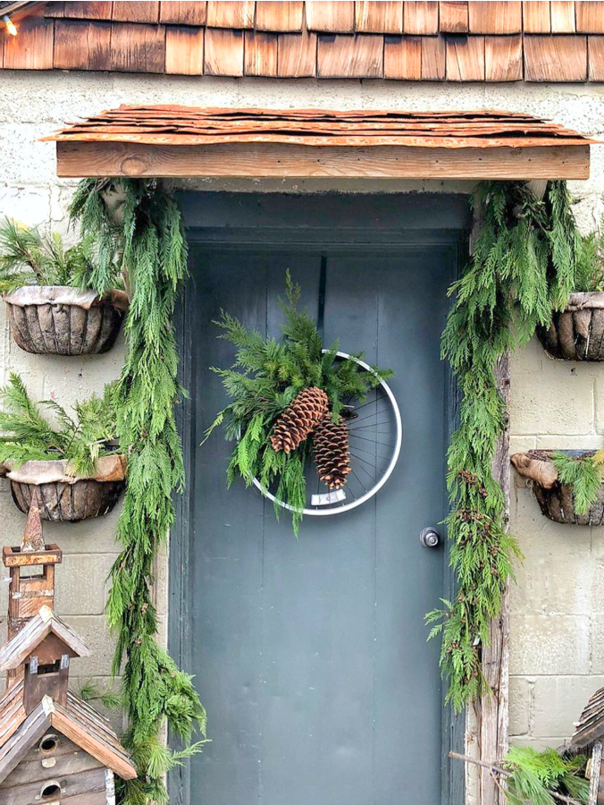 Rustic farmhouse Christmas front door with bicycle wheel wreath at Brambles & Blossoms in Utah - Vivi et Margot. #farmhousechristmas #christmasdecor #frenchfarmhouse #christmasfrontdoor